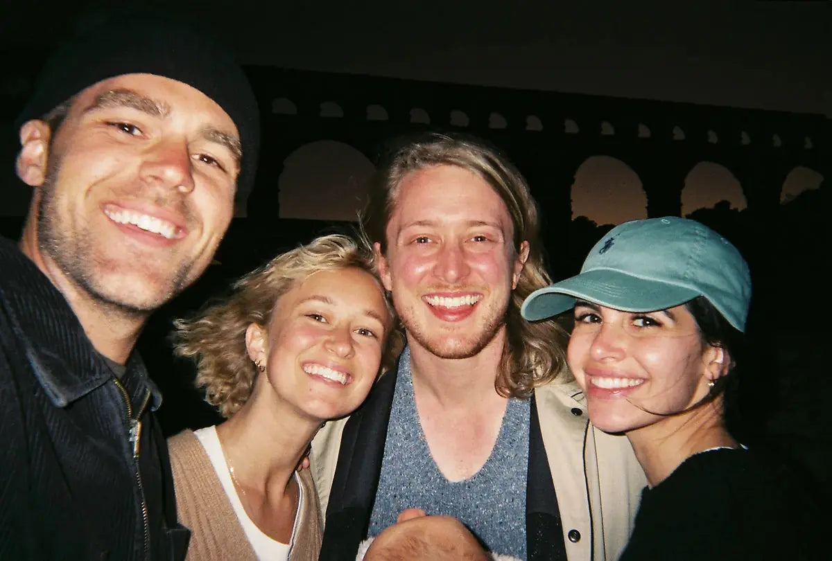 Four friends in a flash-lit group selfie